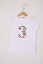 A white kids T-Shirt with a number 3 on the front in Dinosaur Liberty Print