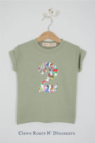 a number 2nd birthday kids sage green t-shirt with a number cut from claws roars n' dinosaurs liberty print on the front.