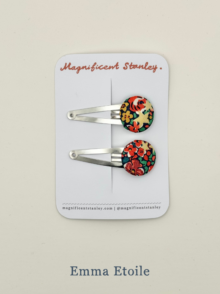 Pair of floral hair clips in Emma Etoile liberty print on a 'Magnificent Stanley' branded card.