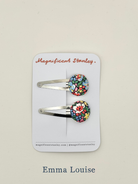Two floral hair clips in liberty emma louise on a 'Magnificent Stanley' branded card.