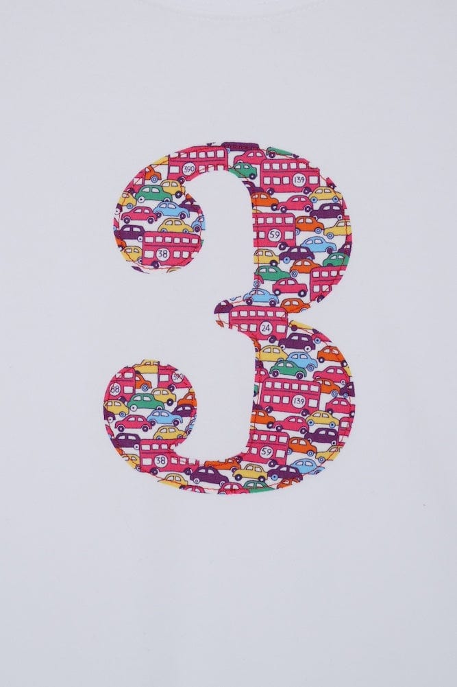 a kids white t-shirt with a number 3 cut from Hop on hop off red cars and london bus liberty print on the front