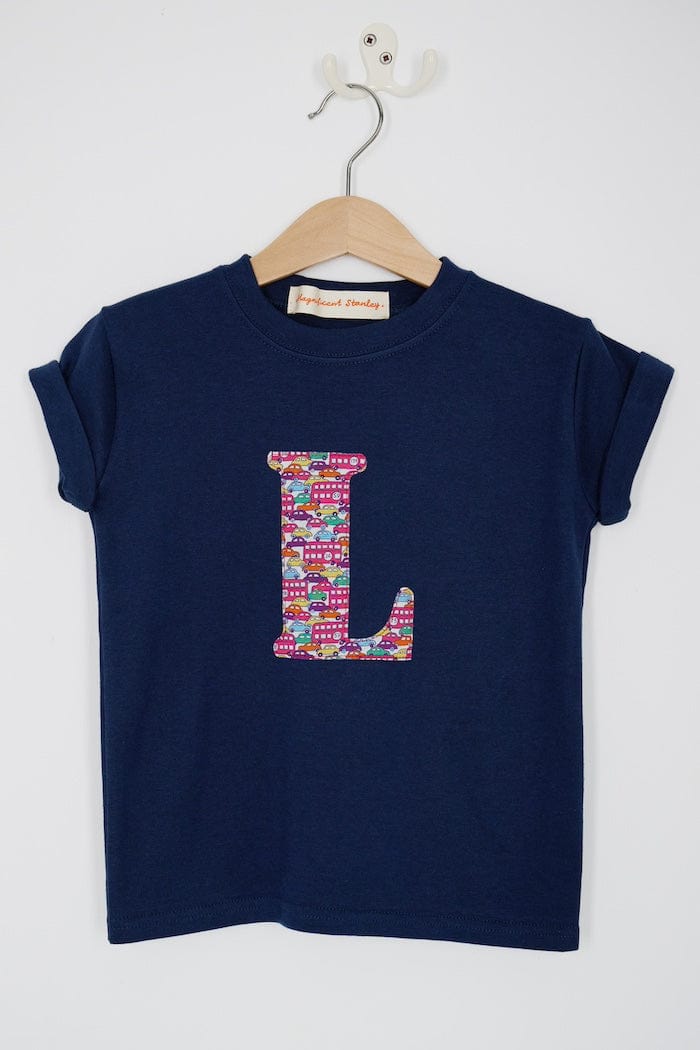 a navy cotton kids t-shirt with the letter 'L' personalised in a red Hop on hop off Liberty print.