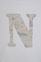 A large embroidered letter 'N' featuring a Liberty Koh & Eito cat print on a light beige background, shown on a plain white fabric.
