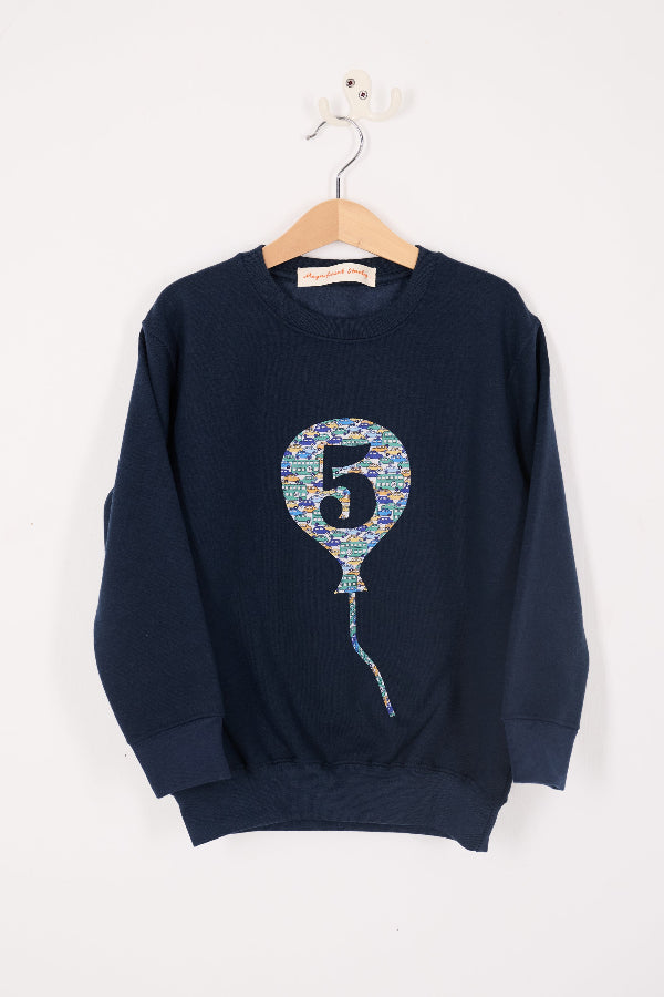 a navy blue sweatshirt with a colourful liberty print balloon design featuring the number 5.