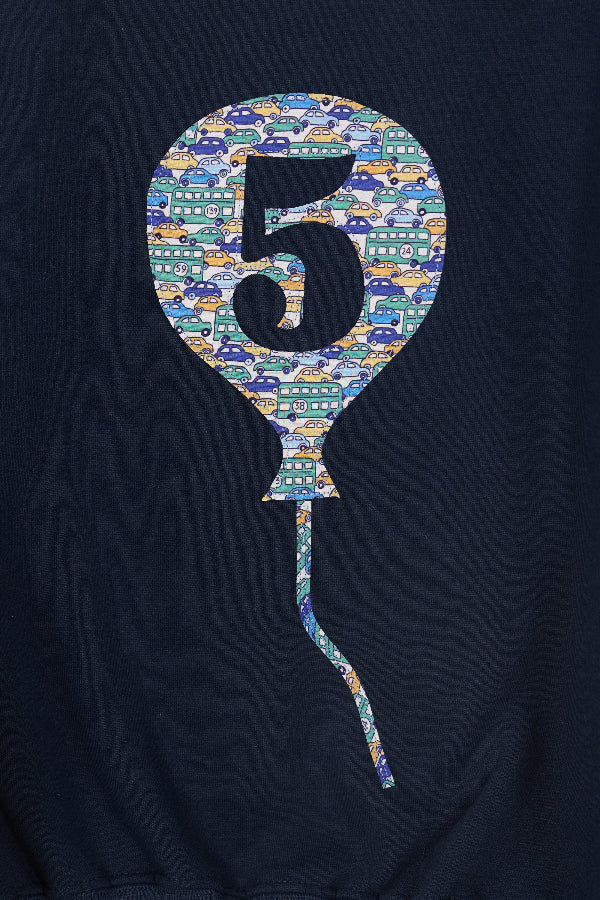 a close up of the stitching on a navy blue sweatshirt with a colourful liberty print balloon design featuring the number 5.