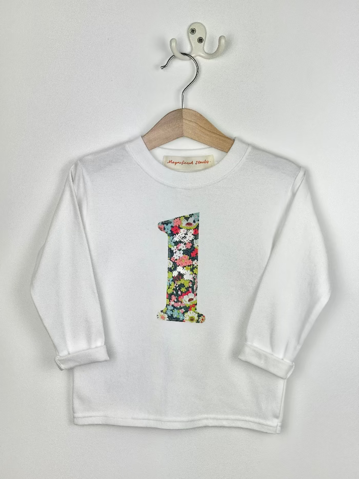 White long-sleeve shirt with a Liberty Thorpe floral number '1' on a hanger against a white background