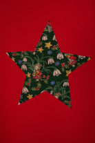 A red long-sleeve sweatshirt with a large star-shaped patch on the chest featuring a Christmas Liberty Elves print. The print features snowdrops, holly, elves, toadstools and stars.