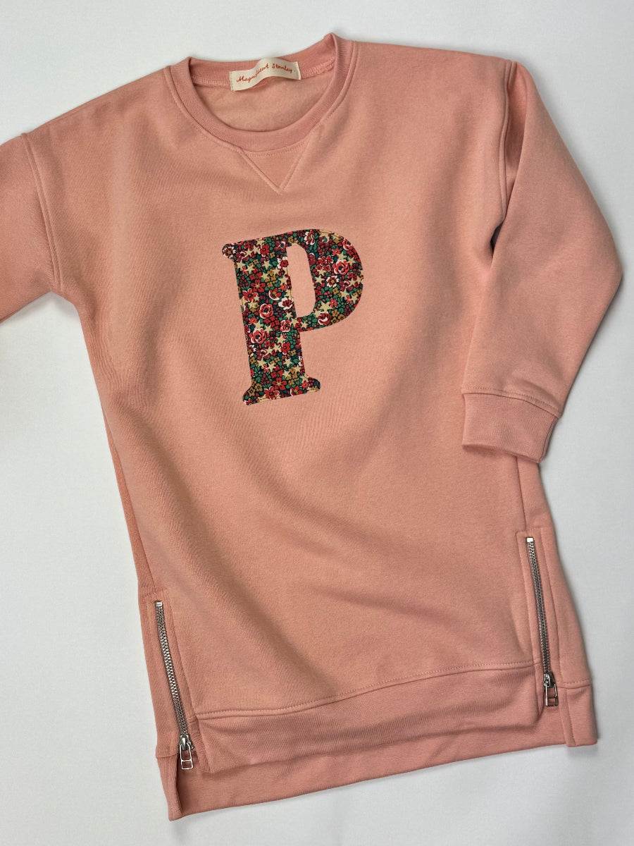 Pink sweatshirt dress with Liberty floral letter 'P' on a white background