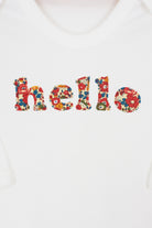 Magnificent Stanley Bodysuit 'hello' Bodysuit in choice of Liberty Print Magnificent Stanley Bodysuit 'hello' Bodysuit.a white bodysuit with the word hello on it. the letters are cut from floral liberty print and shows the appliqué stitching