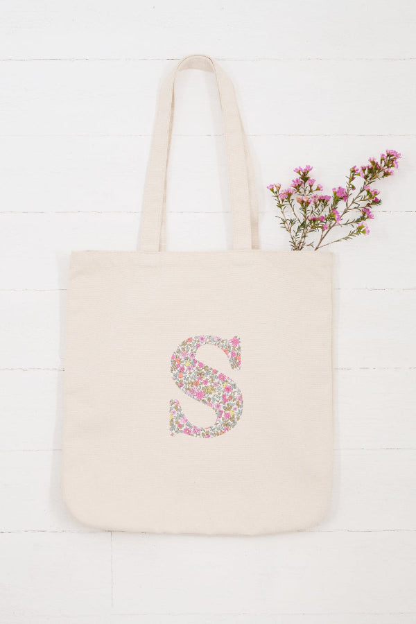 A cream canvas Tote Bag personalised with an initial on in Liberty ditsy floral fabric