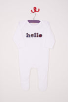 a white cotton romper with the word hello on it. the letters are cut from starry liberty print 