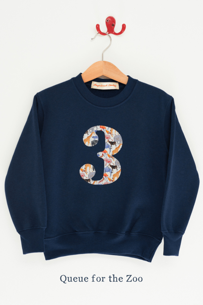A birthday kids navy sweatshirt with a number 3 initial on in Queue for the Zoo  animal Liberty fabric.