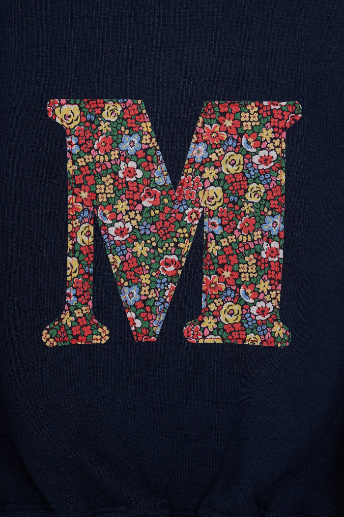 A navy Magnificent Stanley personalised Navy Sweatshirt with her initial on the front in floral emma louise liberty print.