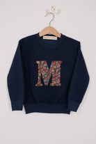 A navy Magnificent Stanley personalised Navy Sweatshirt with her initial on the front in floral emma louise liberty print.