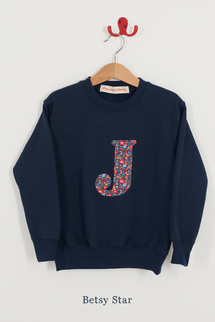 A Magnificent Stanley kids personalised Navy Sweatshirt with an initial on the front in Betsy Star liberty print.