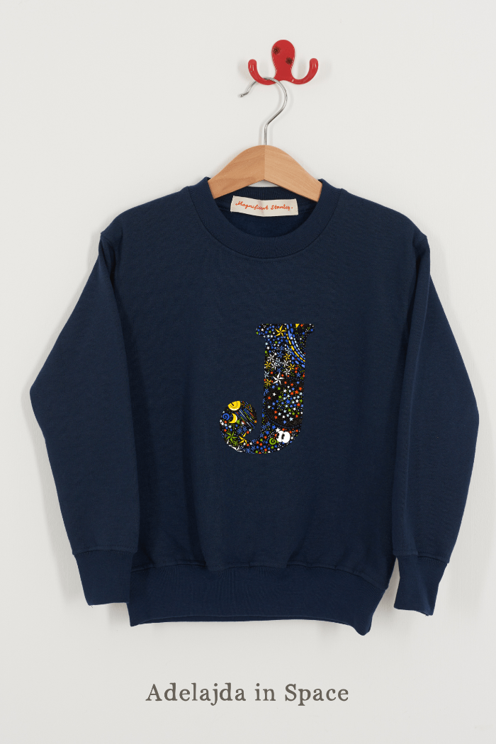 A Magnificent Stanley kids personalised Navy Sweatshirt with an initial on the front in Adelajda in space liberty print.