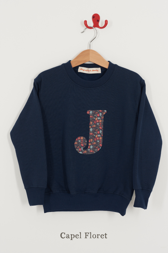 A Magnificent Stanley kids personalised Navy Sweatshirt with an initial on the front in Capel Floret liberty print.