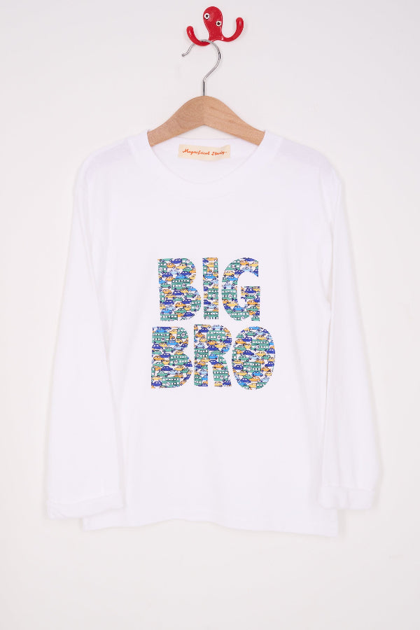 A white cotton t-shirt with BIG BRO sewn onto it in vintage liberty cars print, hanging against a wall