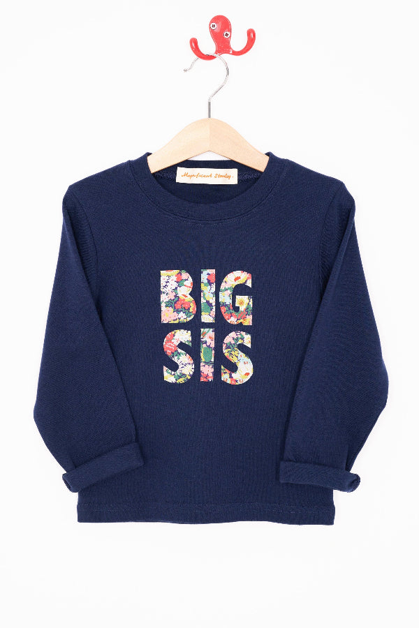 A navy cotton t-shirt with BIG SIS in floral letters on the front. the letters are cut from Liberty print and appliquéd on.
