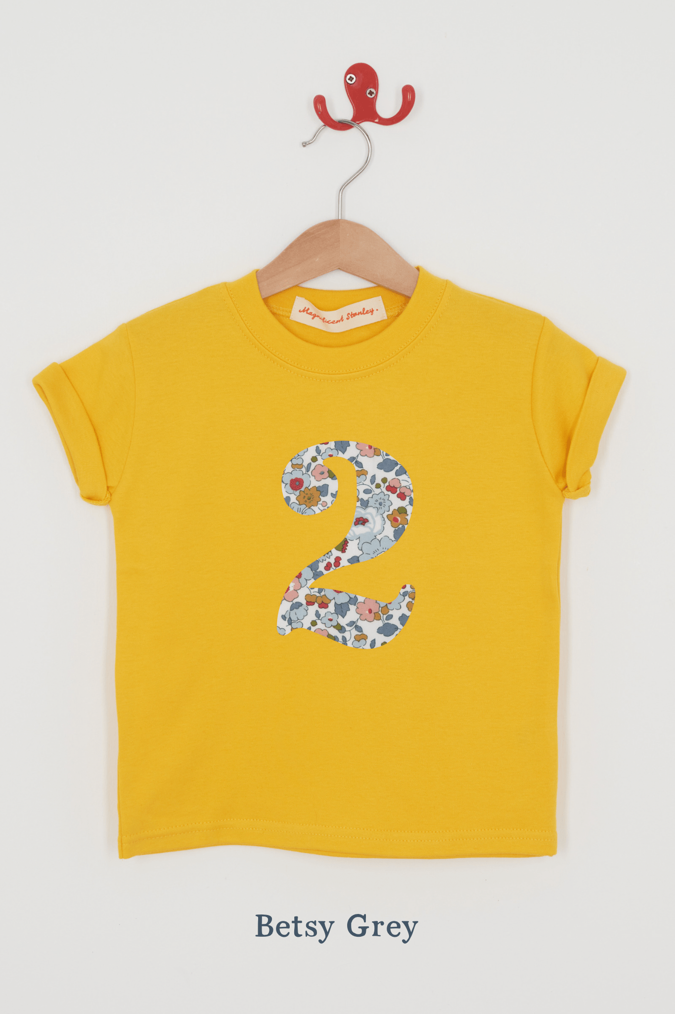 a yellow birthday t-shirt with a number 2 cut from betsy grey liberty floral print on the front.
