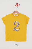 a yellow birthday t-shirt with a number 2 cut from libby liberty floral print on the front.