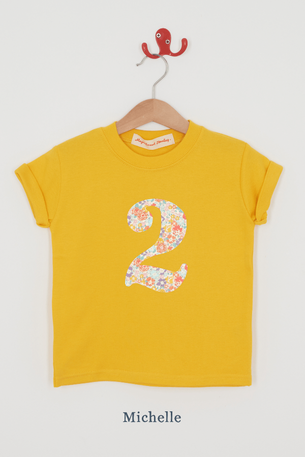 a yellow birthday t-shirt with a number 2 cut from Michelle liberty floral print on the front.