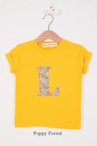 a personalised kids yellow t-shirt with an initial cut from poppy forest liberty floral print on the front