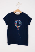 A navy t-shirt with a number 5 in a balloon on the front. The balloon is cut from Ethan's Party balloon Liberty print.