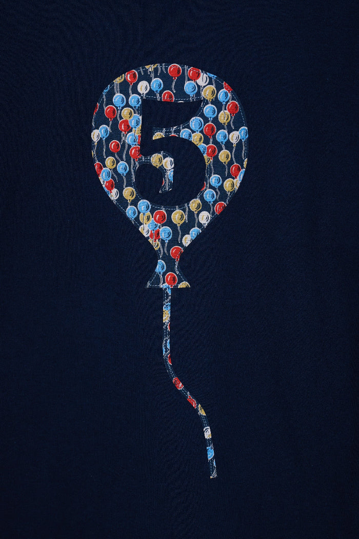 A navy t-shirt with a number 5 in a balloon on the front. The balloon is cut from Ethan's Party balloon Liberty print.