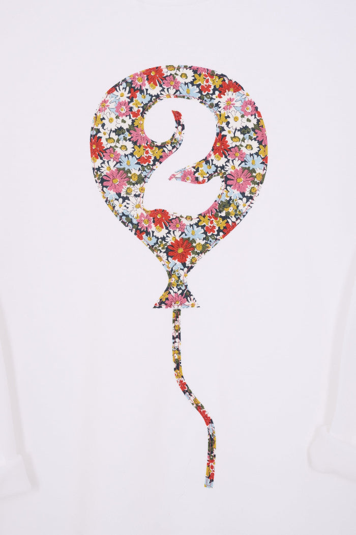 A close up of a 2nd birthday white t-shirt with a balloon and number 2 on it made from Liberty Floral print fabric.