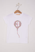 A 3rd birthday white t-shirt with a balloon and number 3 on it made from Liberty Floral print fabric.