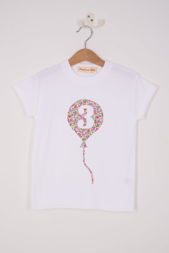 A 3rd birthday white t-shirt with a balloon and number 3 on it made from Liberty Floral print fabric.