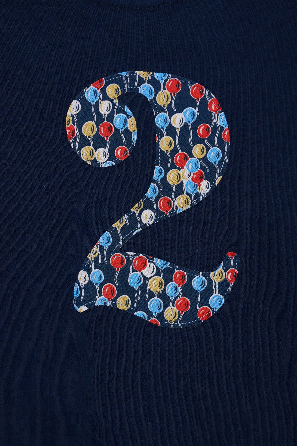 a close up of the appliqué kids Number 4 cotton Navy birthday T-Shirt in Ethan's Party Liberty Print.