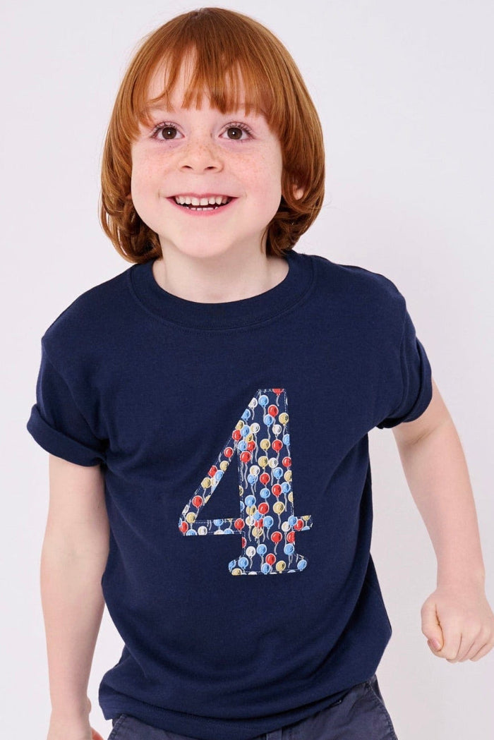 a birthday boy wearing a kids Number 4 Navy T-Shirt in Ethan's Party balloon Liberty Print.