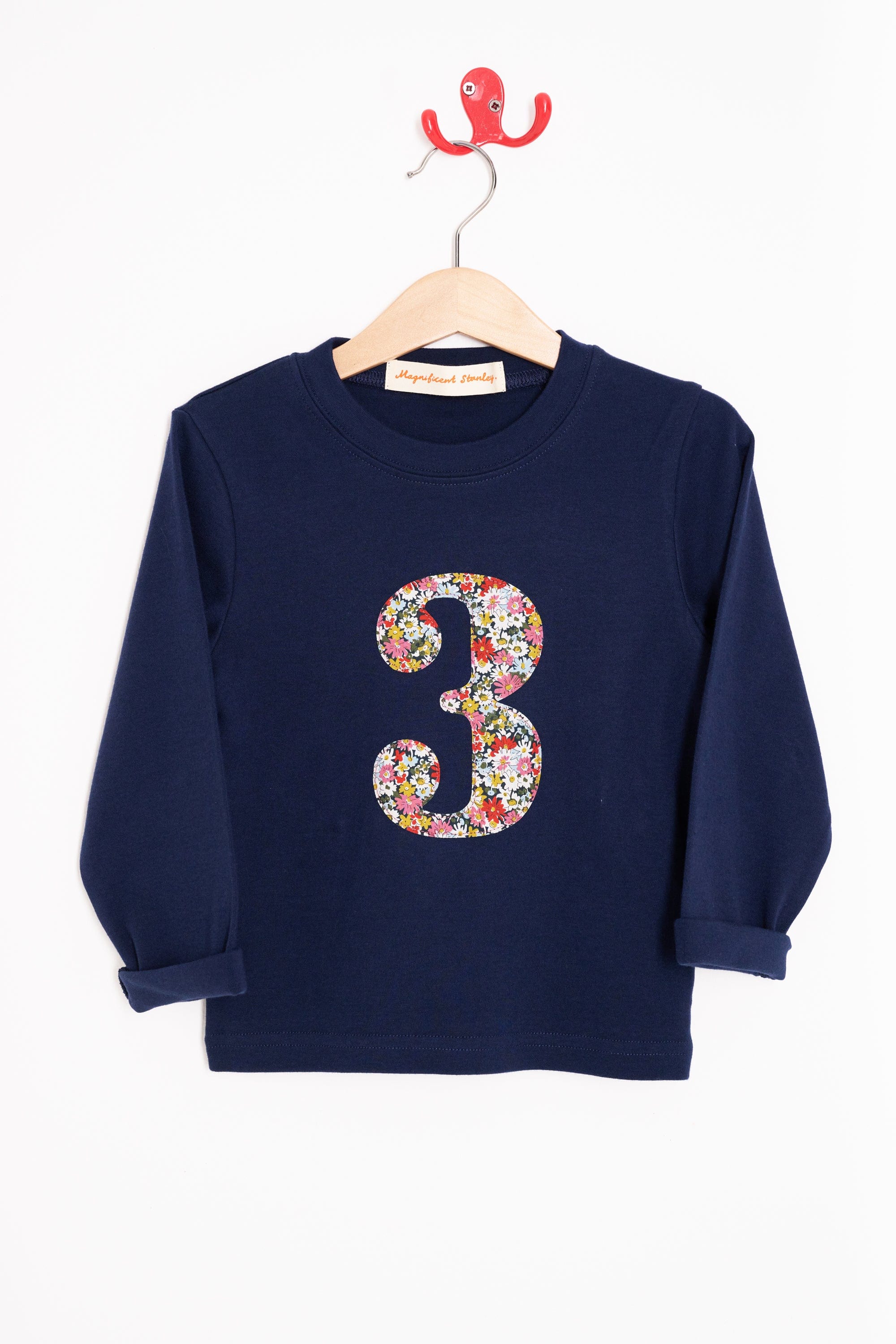 A long sleeve navy t-shirt with a floral liberty number 3 on the front.