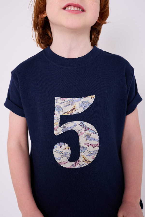 a five year old birthday boy wearing a Magnificent Stanley kids Number Navy T-Shirt in Tom's Jet Liberty Print