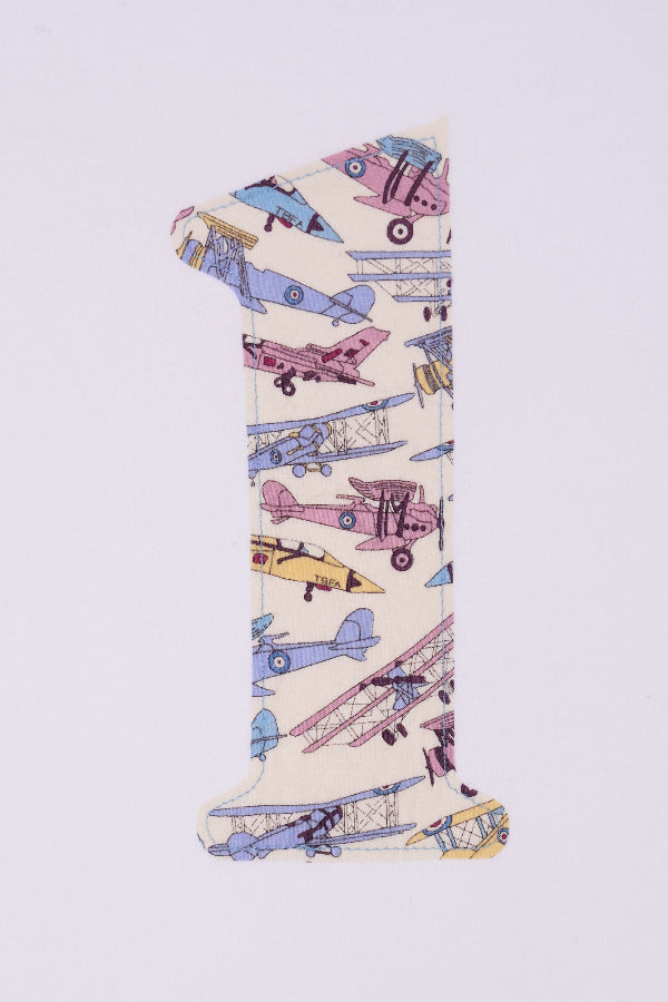 A close up of the sewing on a white cotton t-shirt with a number 1 sewn on the front made from Tom's Jet plane Liberty fabric.