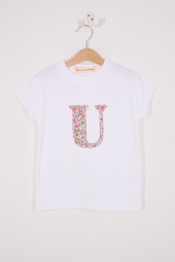 a personalised white cotton T-Shirt with her initial letter on the front in Fruit Punch Liberty Print.