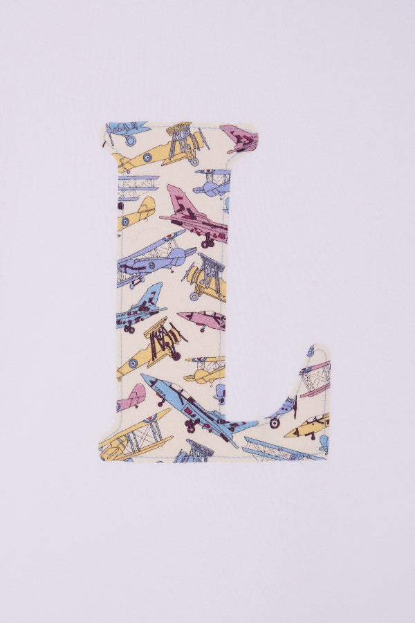 a personalised white cotton T-Shirt with an initial letter on the front in Toms Jet plane Liberty print