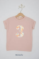 a pink 3rd birthday t-shirt with a number 3 cut from michelle liberty floral print on the front