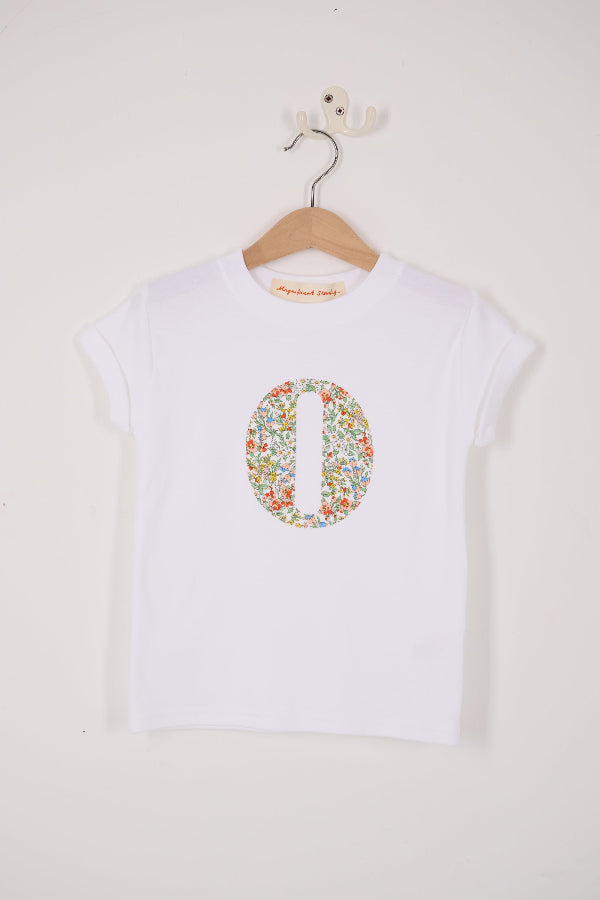 A summery personalised white cotton t-shirt with an initial cut from Nazanin floral liberty fabric.