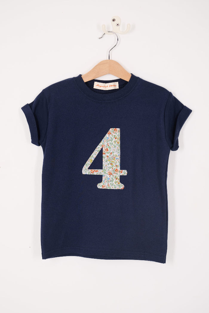 A close up of a navy cotton t-shirt with the number 4 sewn on the front cut from liberty floral Nazanin print.