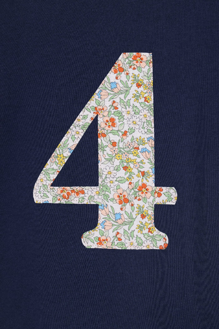 A close up of a navy cotton t-shirt with the number 4 sewn on the front cut from liberty floral Nazanin print.