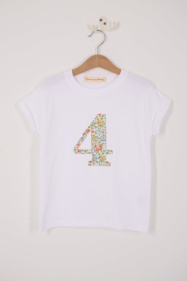 A white cotton birthday t-shirt with the number 4 sewn on the front cut from liberty Nazanin fabric