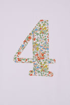 A white cotton birthday t-shirt with the number 4 sewn on the front cut from liberty Nazanin fabric