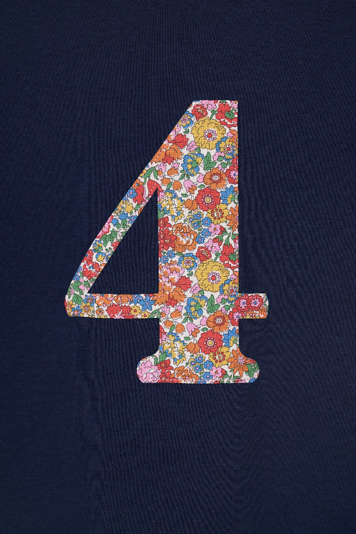 A close up of a navy cotton t-shirt with the number 4 sewn on the front cut from liberty floral Nell Annie and May print.