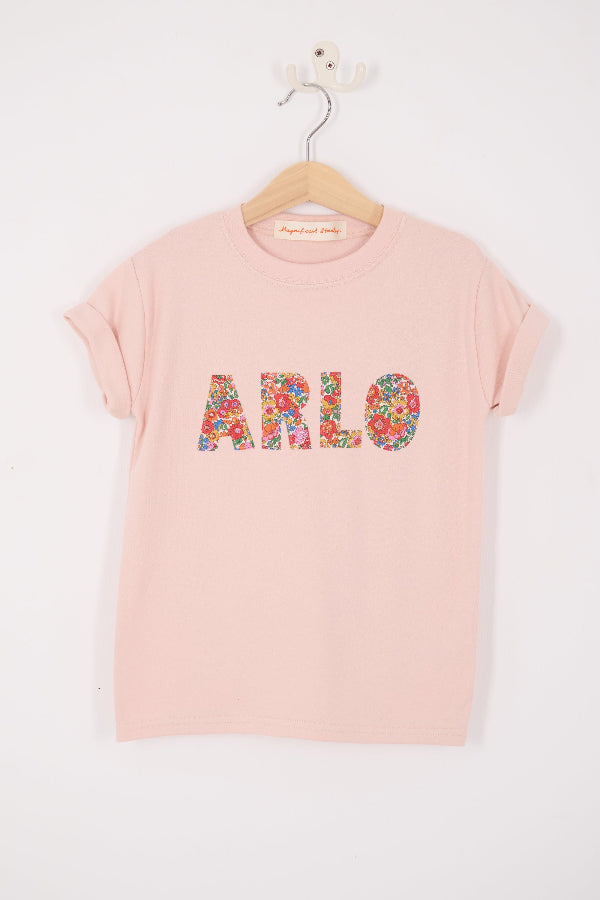 a pink t-shirt with her name on the front in Liberty Nell Annie May floral print.