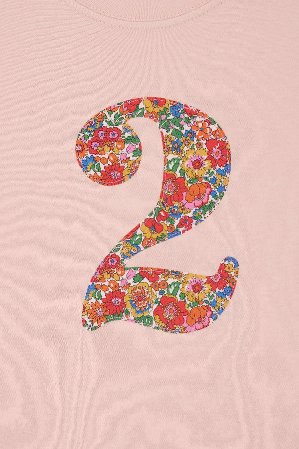 a pale pink t-shirt with a Liberty Nell Annie and May floral number '2' on the front