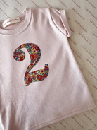 a pale pink birthday t-shirt with a floral liberty number 2 sewn on the front