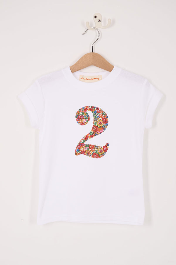 A white cotton birthday t-shirt with the number 2 sewn on the front cut from liberty Nell Annie and May fabric